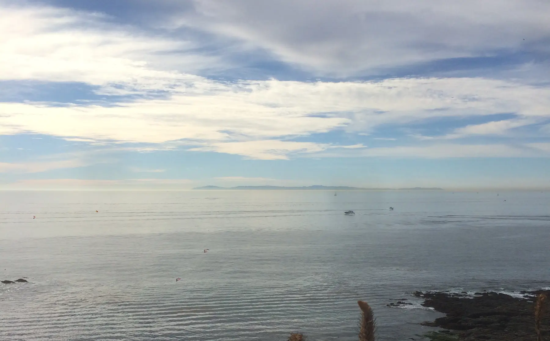 Ocean and cloudy sky with rocks
